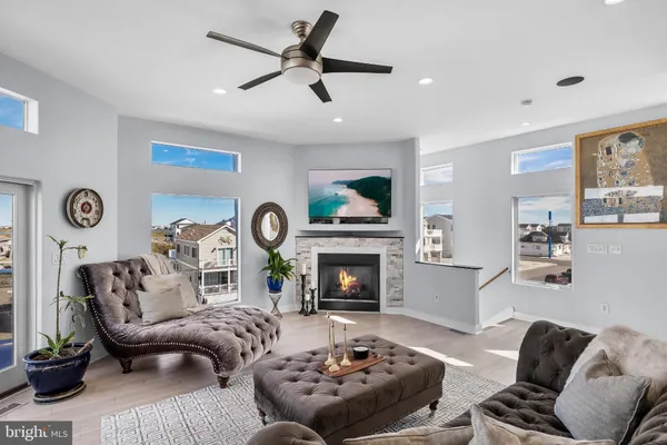 a kitchen with granite countertop a sink a counter top space and living room view