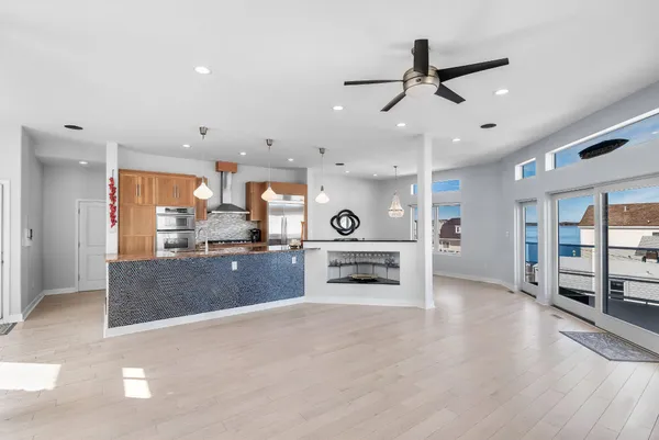 a kitchen with kitchen island a counter top space and stainless steel appliances