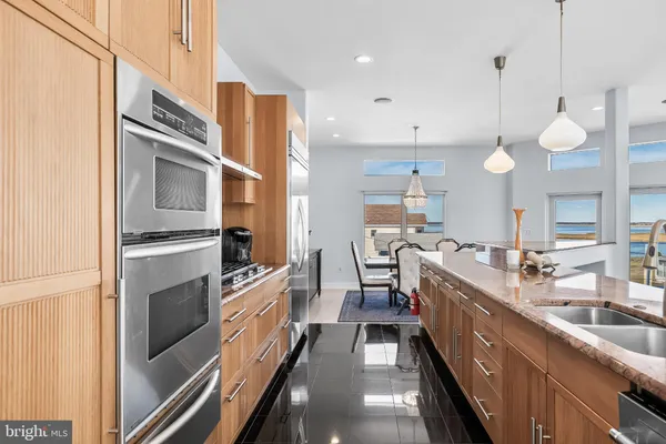 a kitchen with a sink a refrigerator a stove a microwave and cabinets