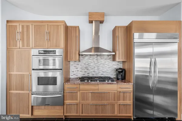 a kitchen with stainless steel appliances granite countertop a sink stove and microwave