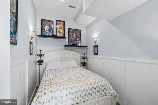 a bedroom with a bed and a large window with the outer view