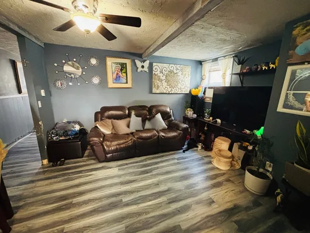 a bedroom with furniture and wooden floor