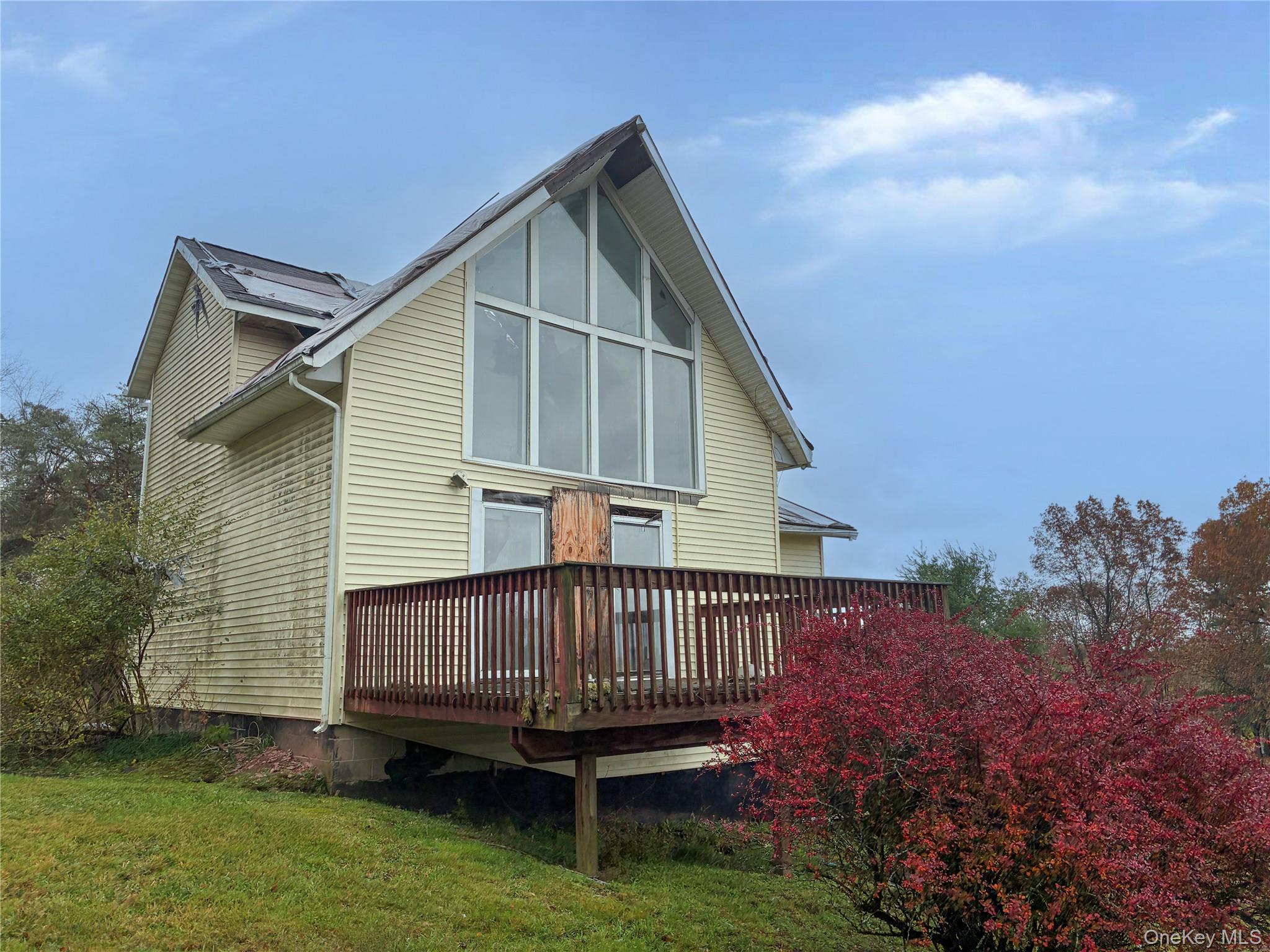 938 Horseshoe Lake Road Swan Lake, NY 12783 - Photo 2 of 8 a view of a house with a wooden deck and a yard
