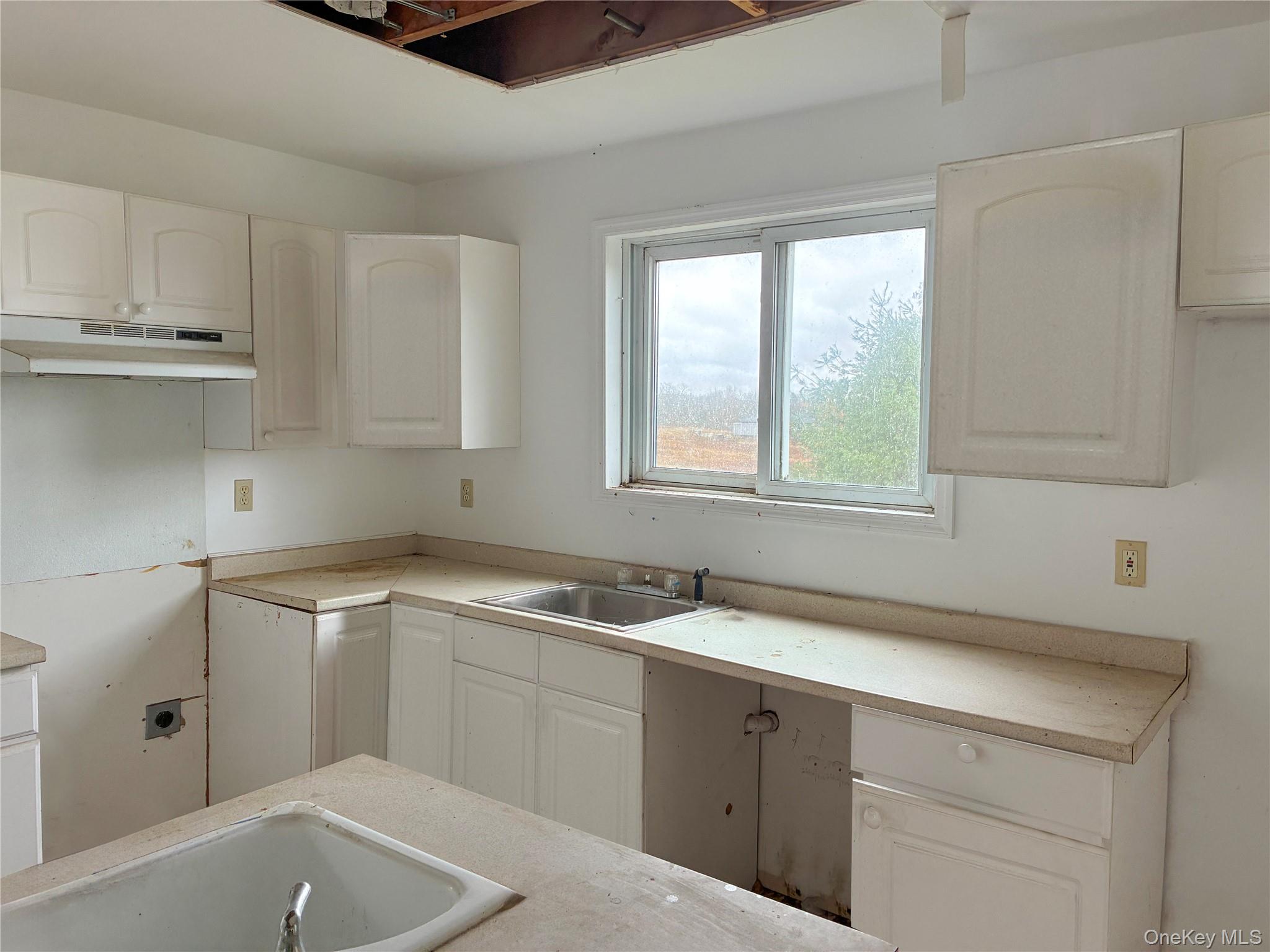 938 Horseshoe Lake Road Swan Lake, NY 12783 - Photo 4 of 8 a kitchen with a sink cabinets and window
