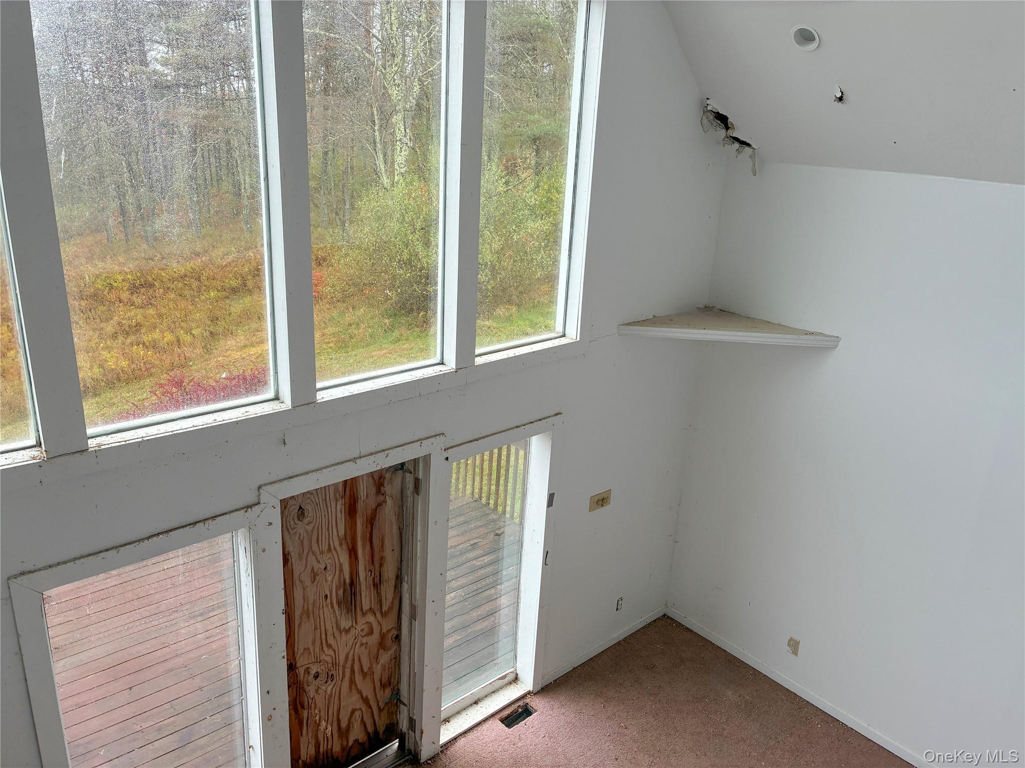 938 Horseshoe Lake Road Swan Lake, NY 12783 - Photo 6 of 8 a view of an empty room with a window