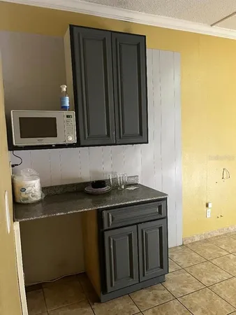 a kitchen with stainless steel appliances granite countertop a sink stove and microwave