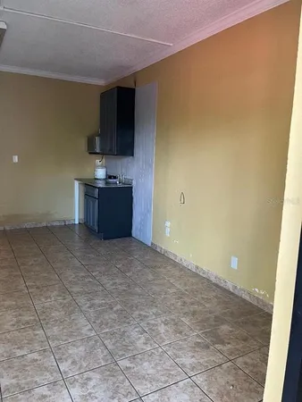 a view of a kitchen with a sink and a refrigerator