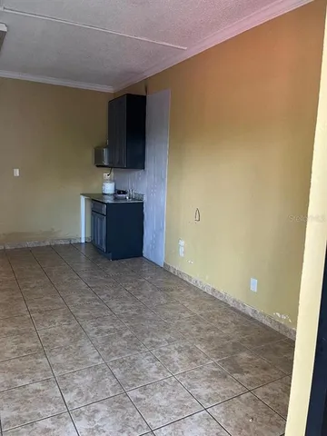a view of a kitchen with a sink and a refrigerator