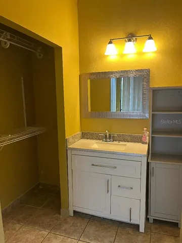 a white toilet sitting next to a white sink