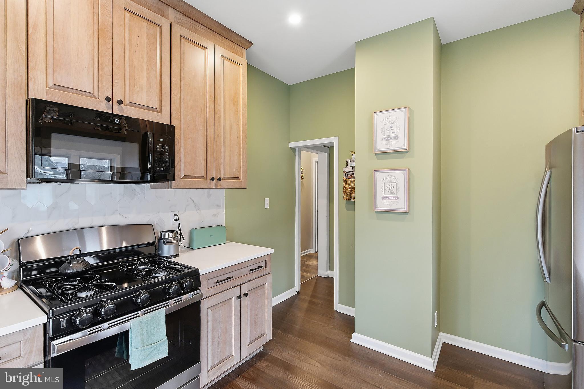 174 Crest Avenue Hamilton, NJ 08690 - Photo 13 of 29 a kitchen with stainless steel appliances granite countertop a stove and a refrigerator