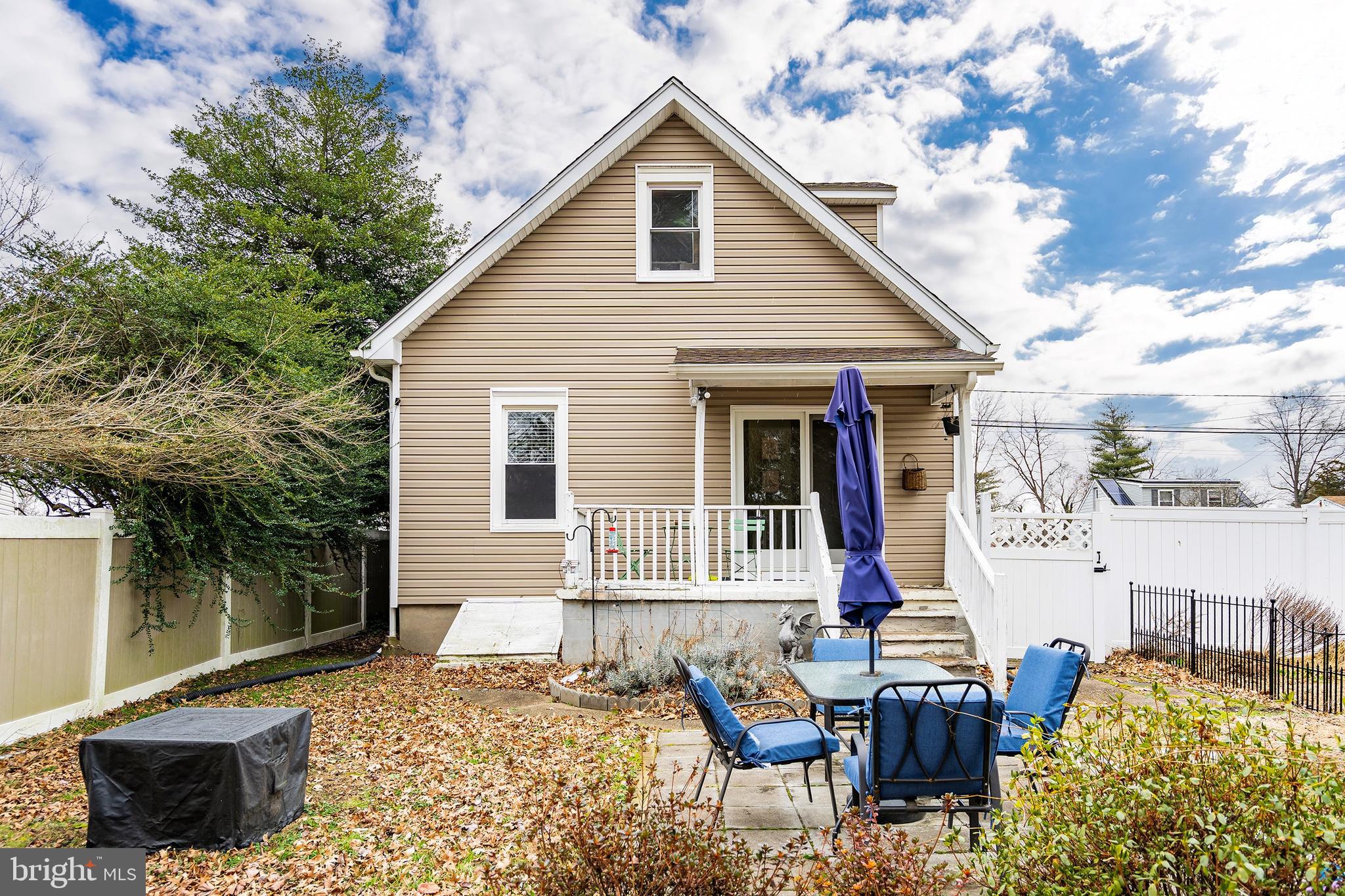 174 Crest Avenue Hamilton, NJ 08690 - Photo 24 of 29 a view of backyard of house with wooden chairs and floor to ceiling window