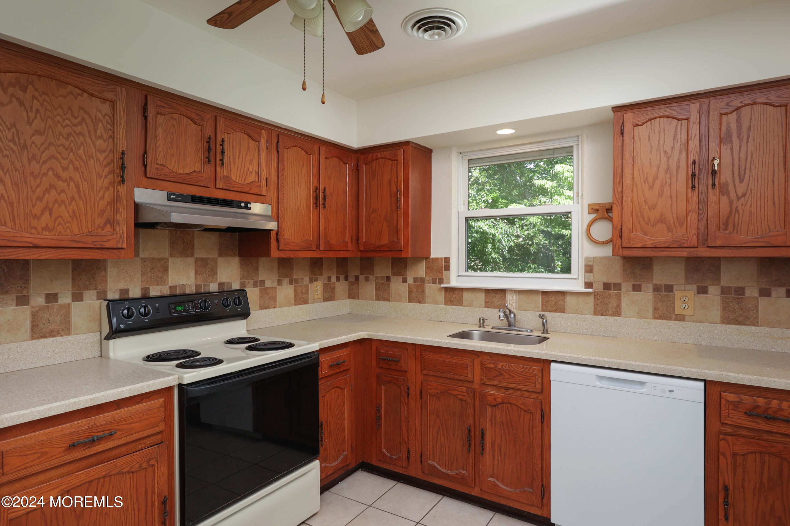 147A Sunset Road, Unit B Whiting, NJ 08759 - Photo 11 of 23 a kitchen with stainless steel appliances granite countertop a sink stove and cabinets