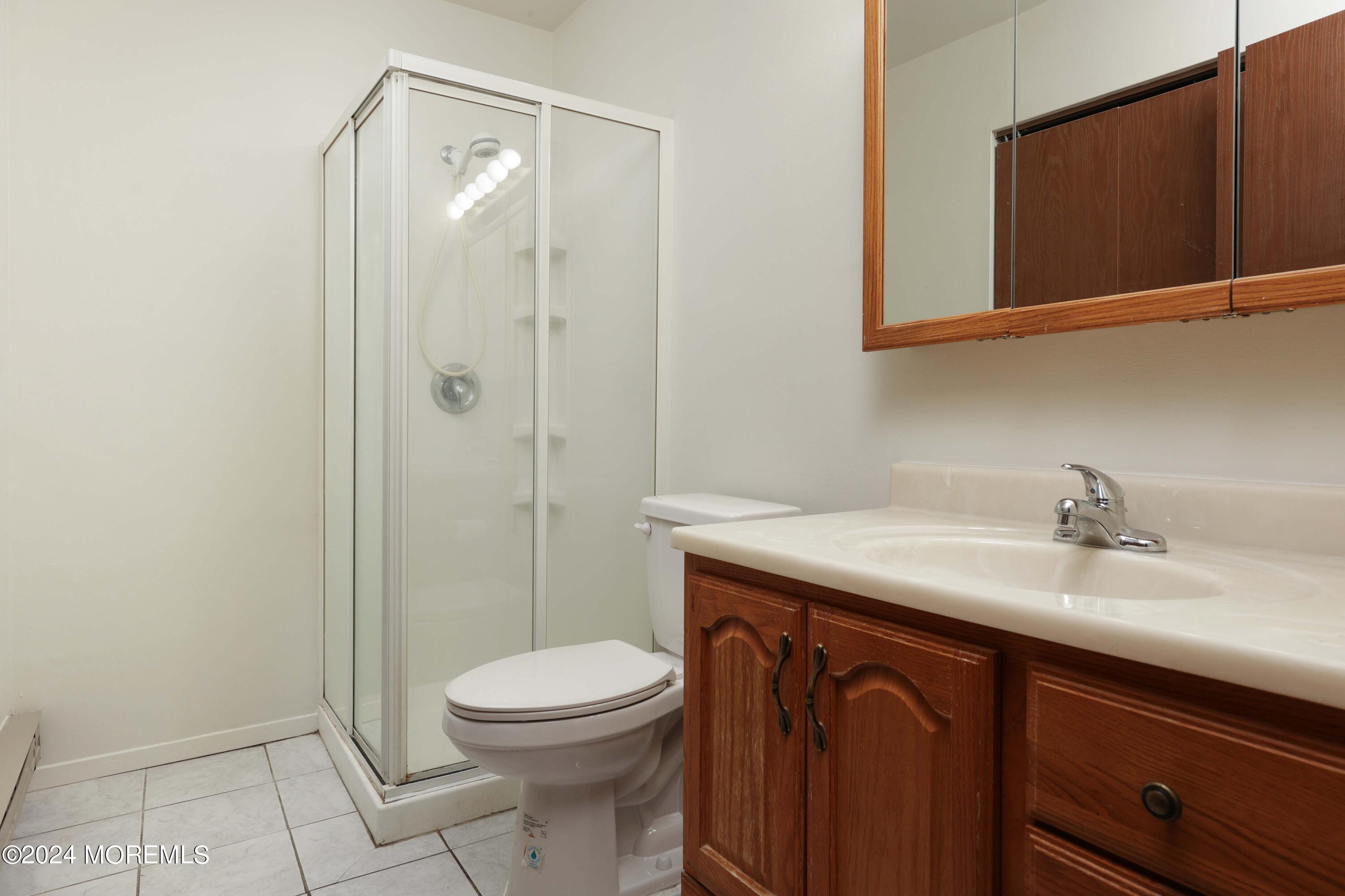 147A Sunset Road, Unit B Whiting, NJ 08759 - Photo 12 of 23 a bathroom with a granite countertop sink a toilet and shower