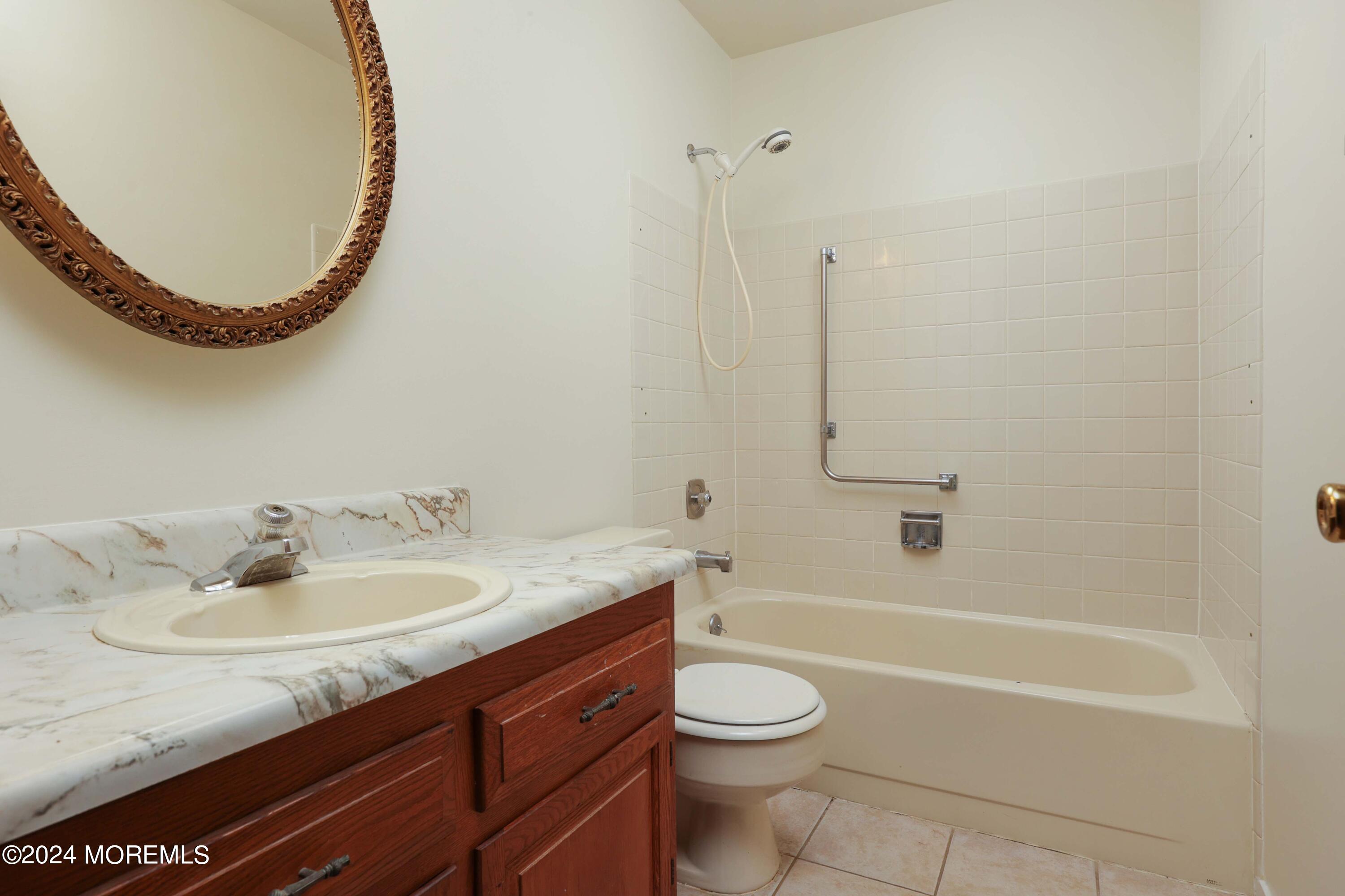 147A Sunset Road, Unit B Whiting, NJ 08759 - Photo 14 of 23 a bathroom with a granite countertop sink and a mirror