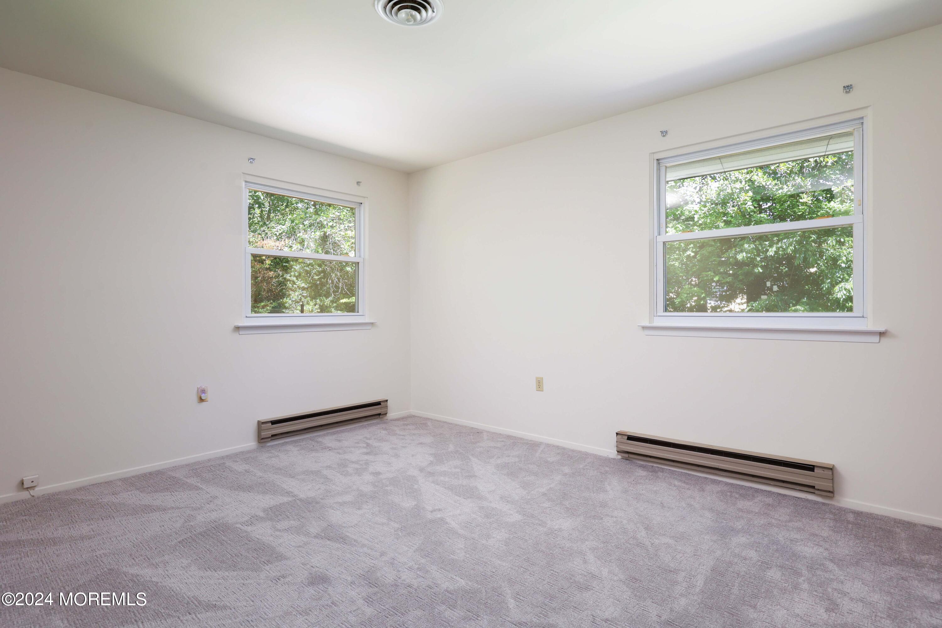 147A Sunset Road, Unit B Whiting, NJ 08759 - Photo 16 of 23 an empty room with a window