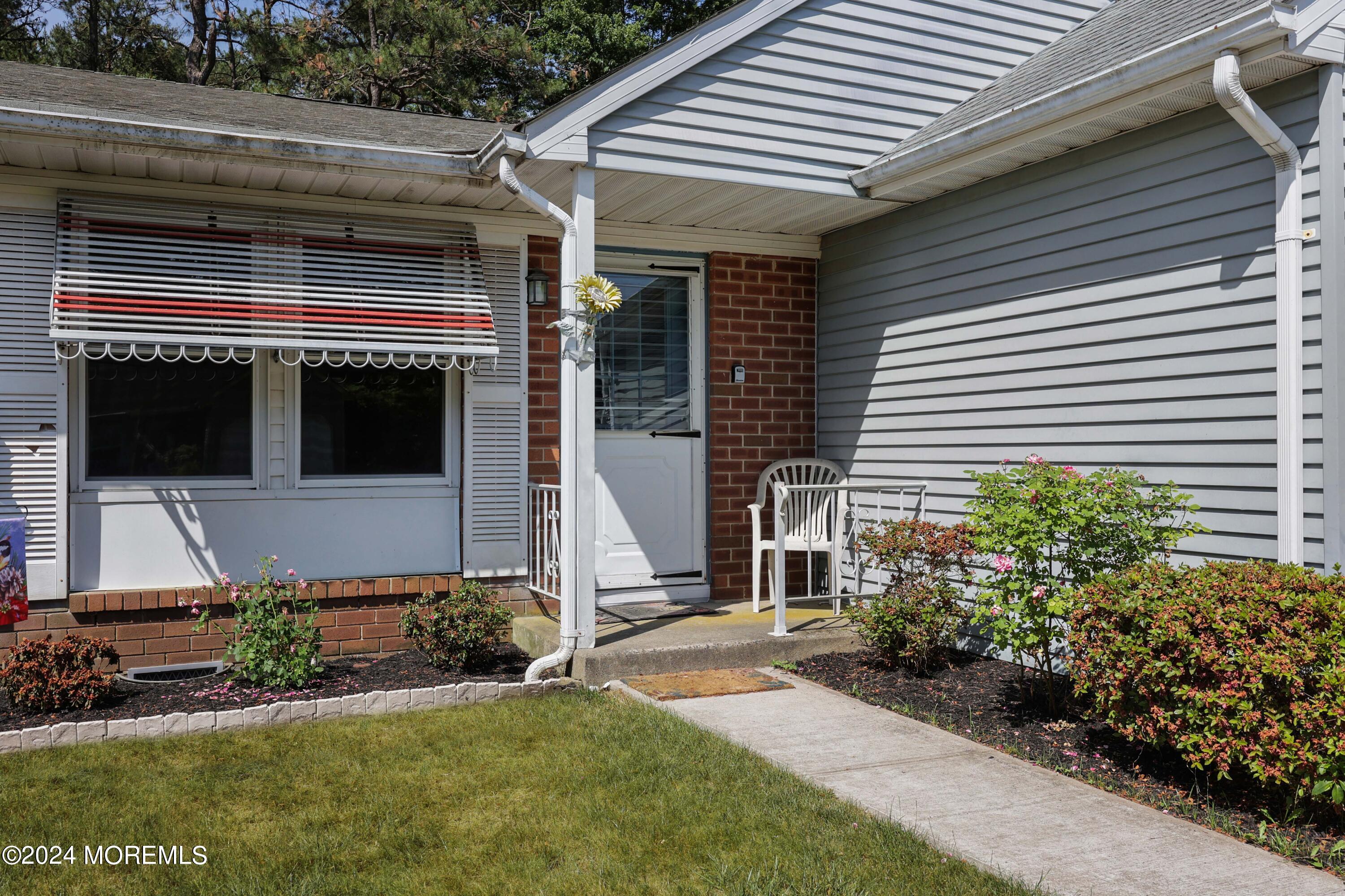 147A Sunset Road, Unit B Whiting, NJ 08759 - Photo 2 of 23 a front view of a house with a yard