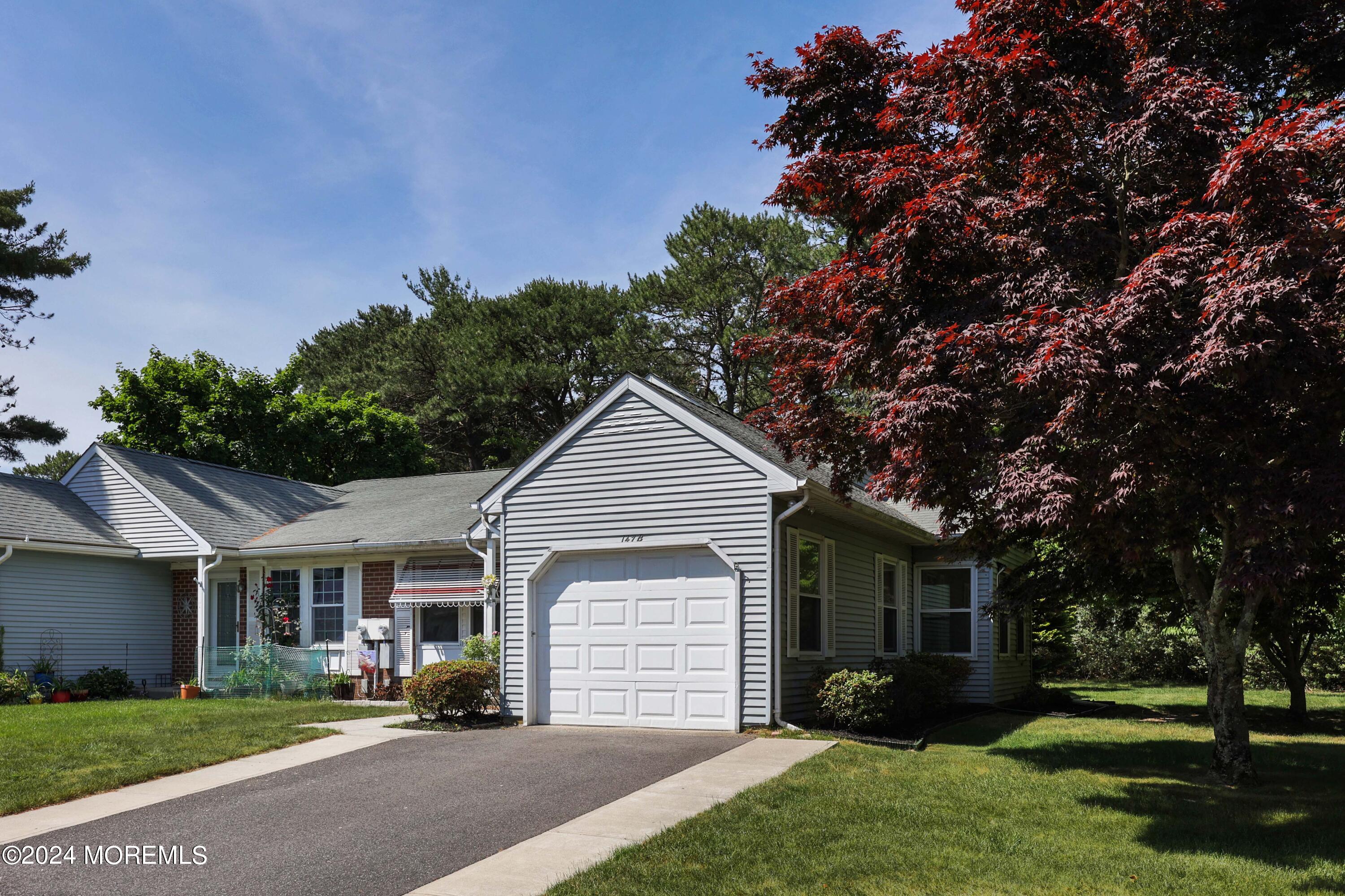147A Sunset Road, Unit B Whiting, NJ 08759 - Photo 22 of 23 a front view of a house with a garden and trees