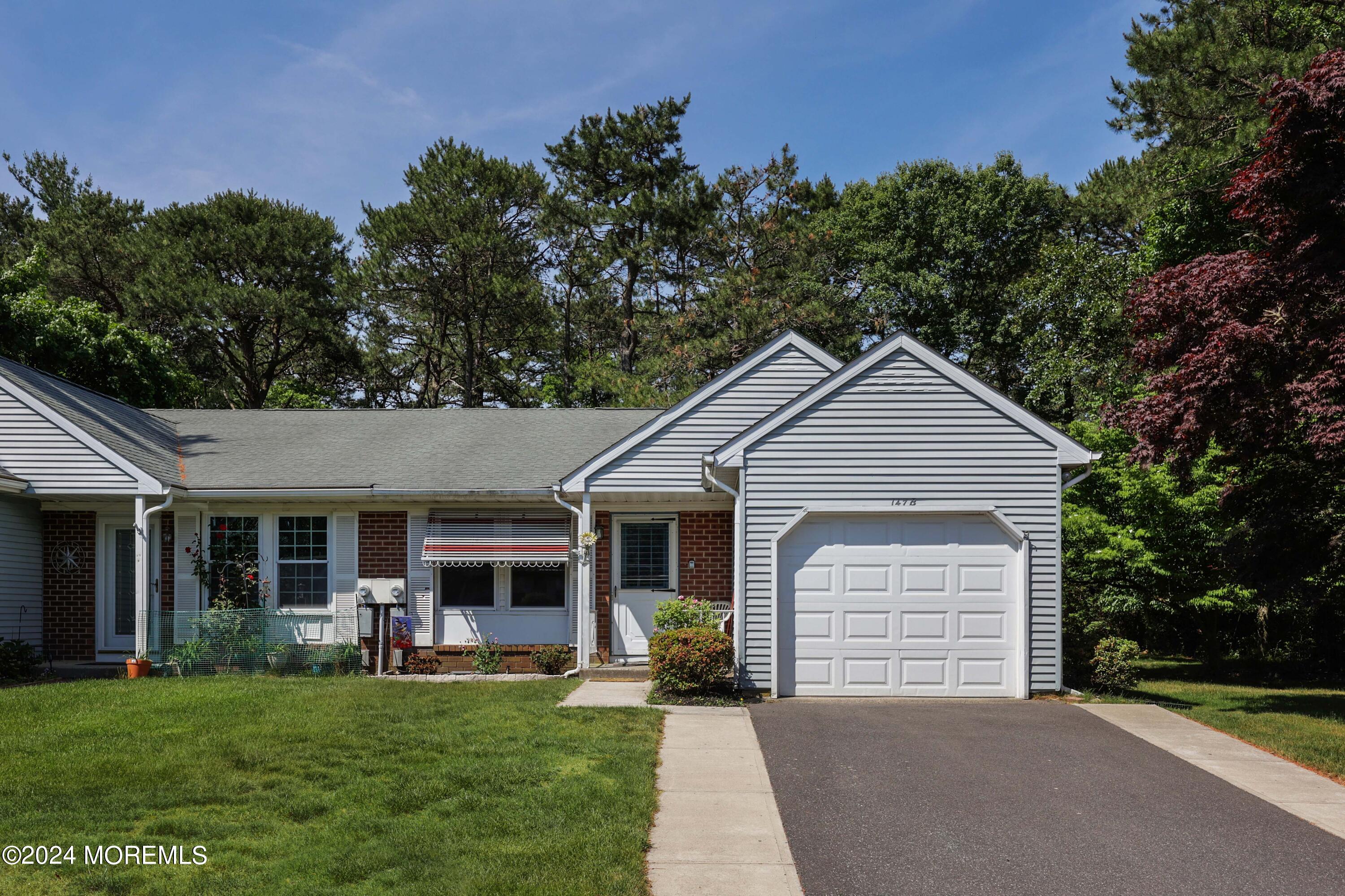 147A Sunset Road, Unit B Whiting, NJ 08759 - Photo 23 of 23 a front view of a house with a garden and yard