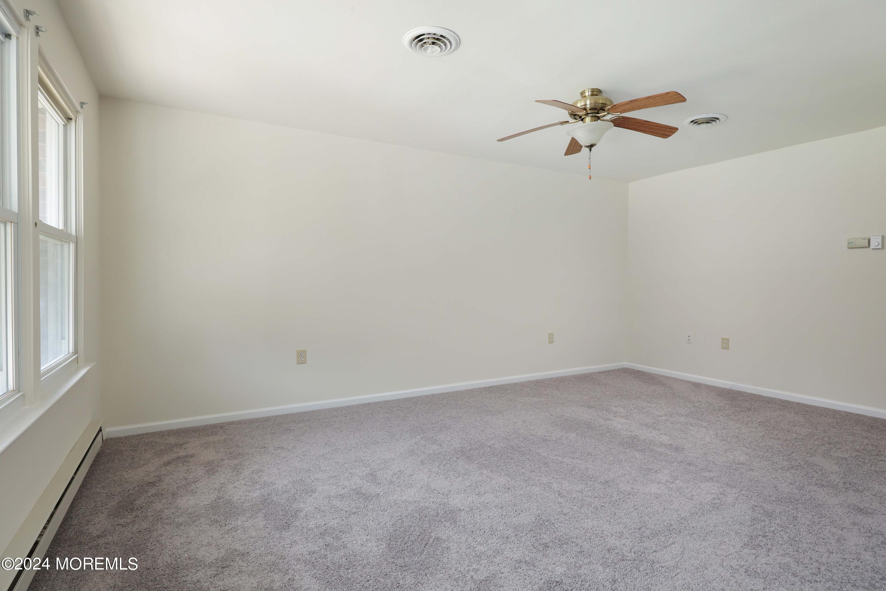 147A Sunset Road, Unit B Whiting, NJ 08759 - Photo 4 of 23 a view of an empty room with a window