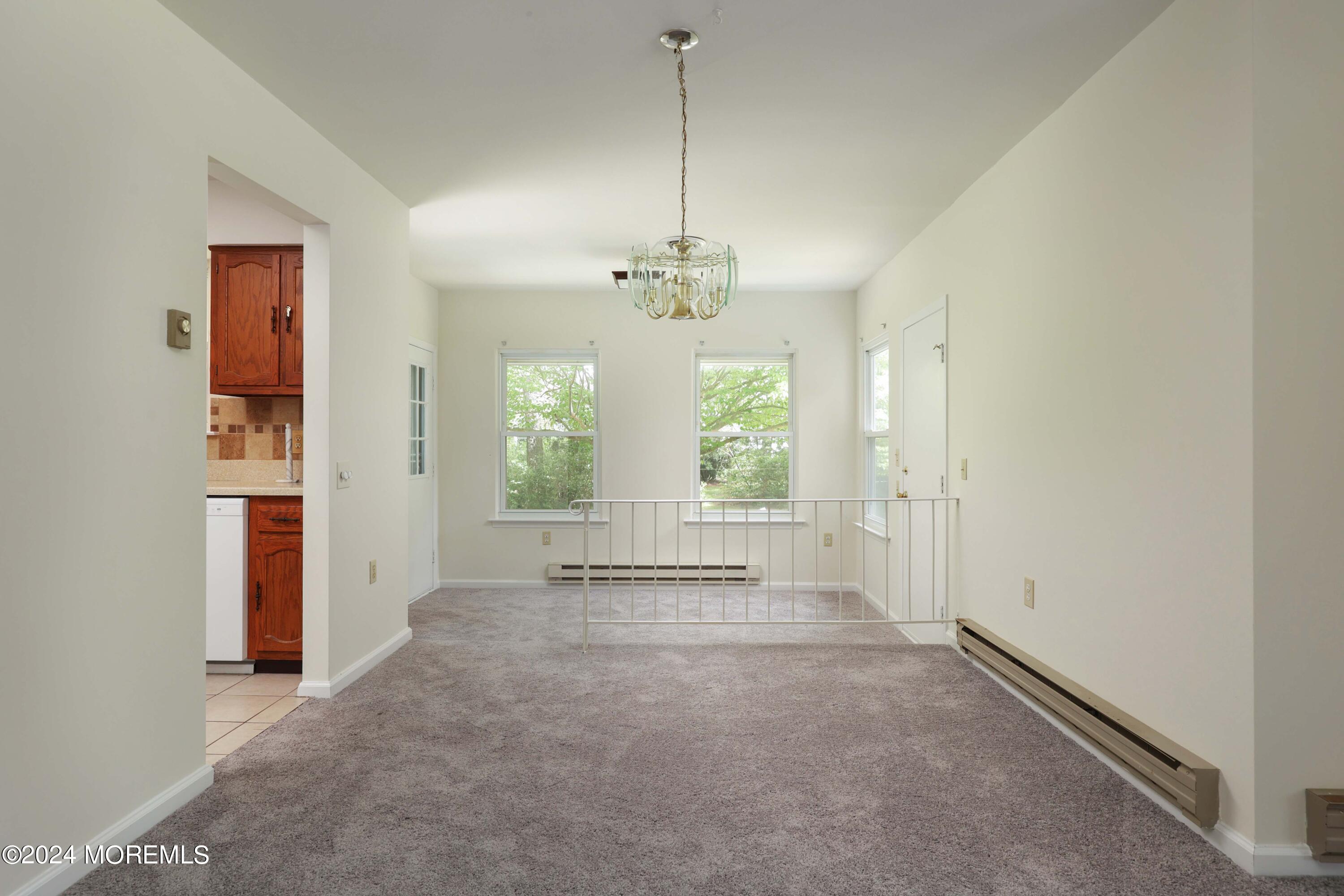 147A Sunset Road, Unit B Whiting, NJ 08759 - Photo 7 of 23 a view of a room with window ceiling fan and windows