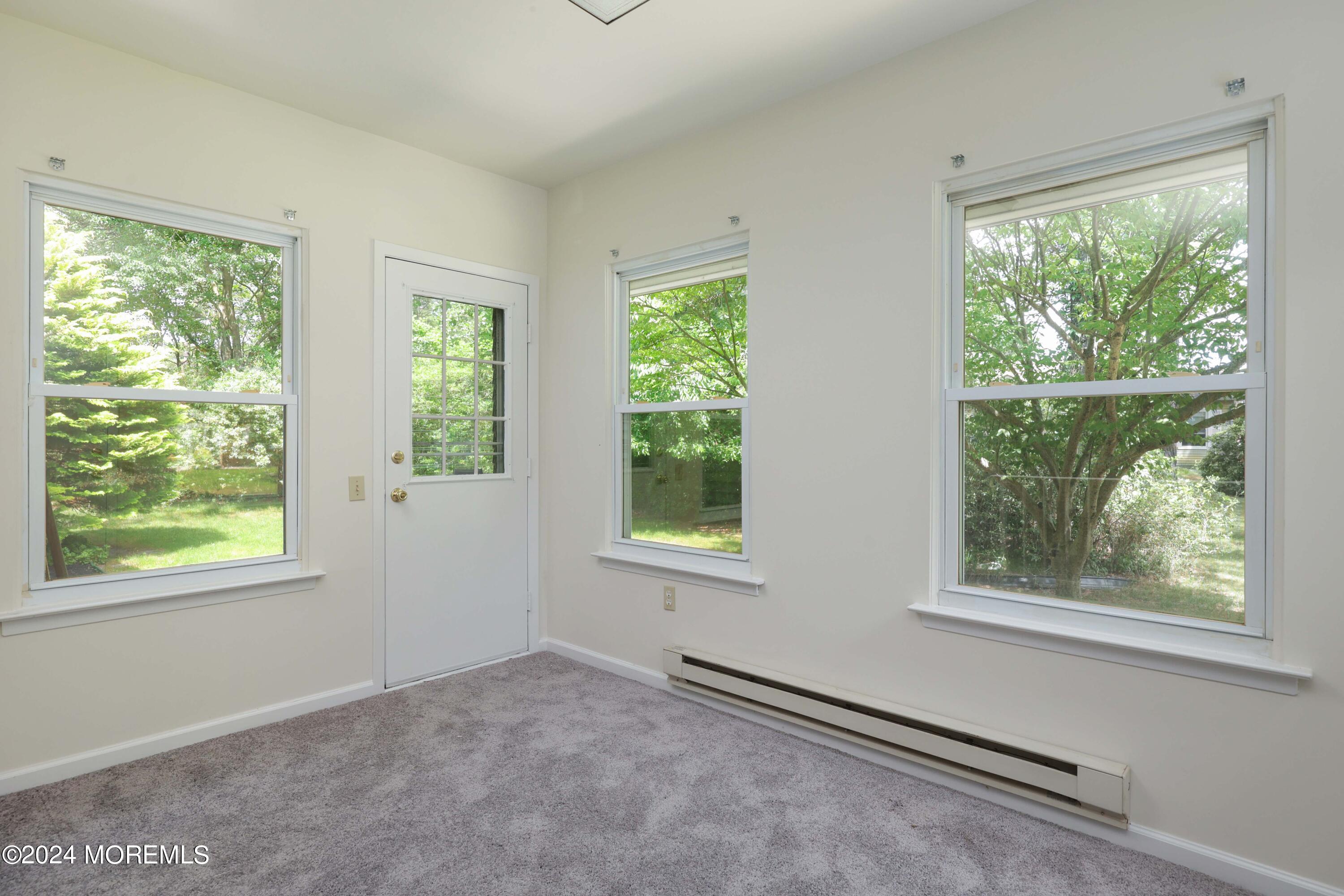 147A Sunset Road, Unit B Whiting, NJ 08759 - Photo 8 of 23 a view of an empty room with windows