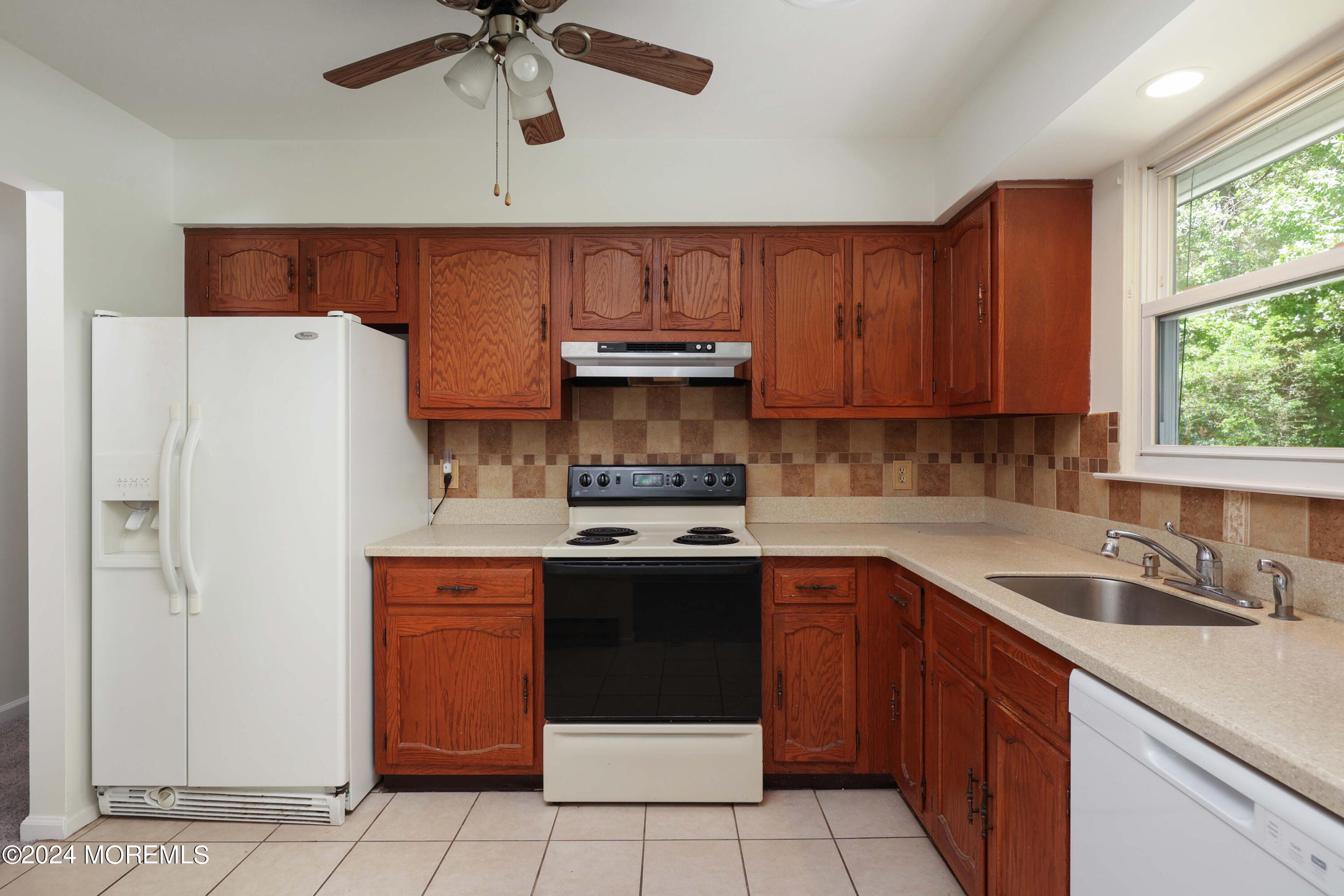 147A Sunset Road, Unit B Whiting, NJ 08759 - Photo 9 of 23 a kitchen with granite countertop a sink stainless steel appliances and cabinets