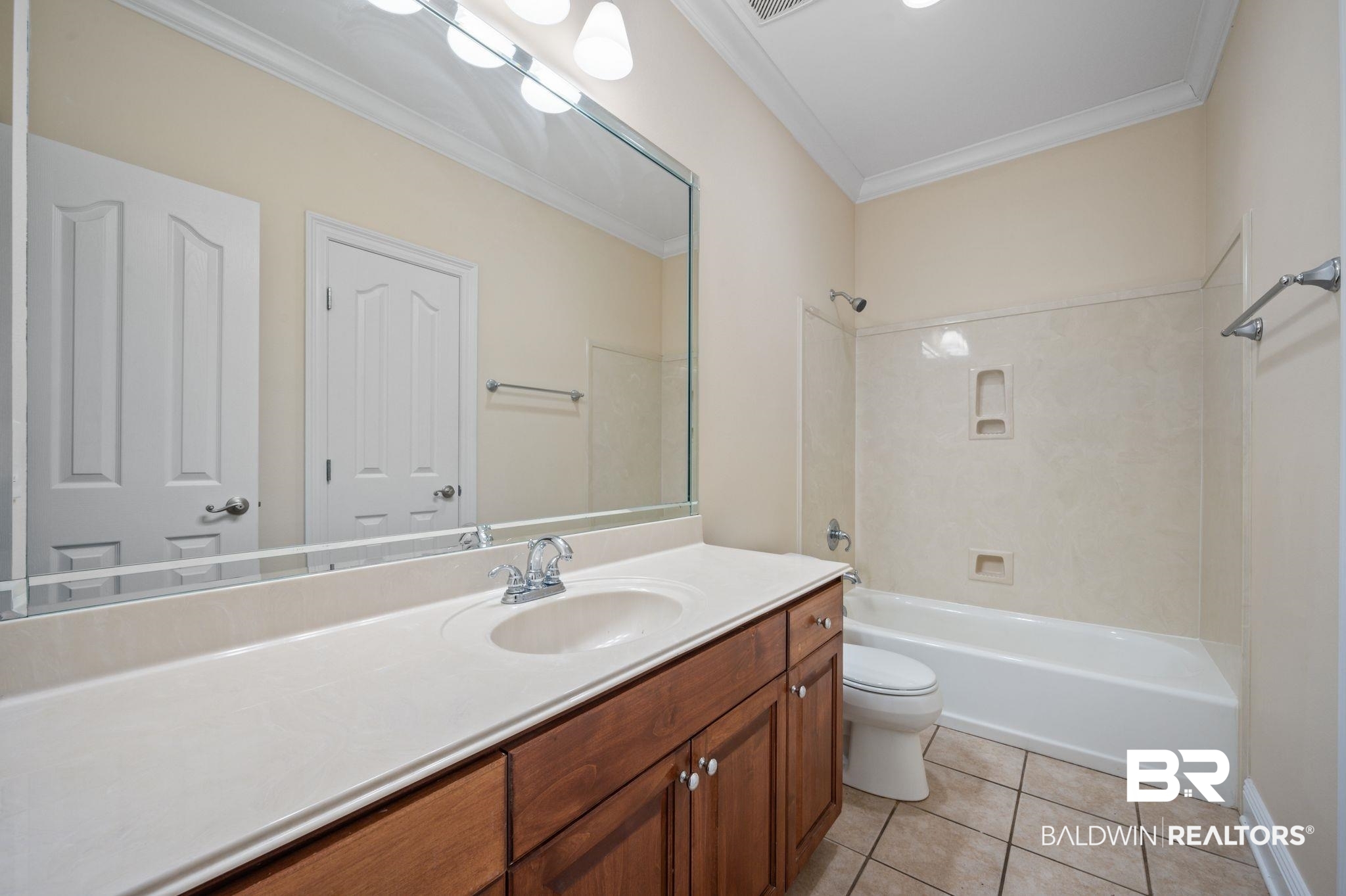 2041 Ridgeline Drive Mobile, AL 36695 - Photo 20 of 43 Full bathroom with tile patterned flooring, shower / bath combination, toilet, vanity, and ornamental molding