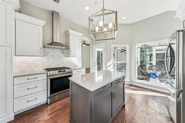 a kitchen with stainless steel appliances granite countertop a stove and a refrigerator