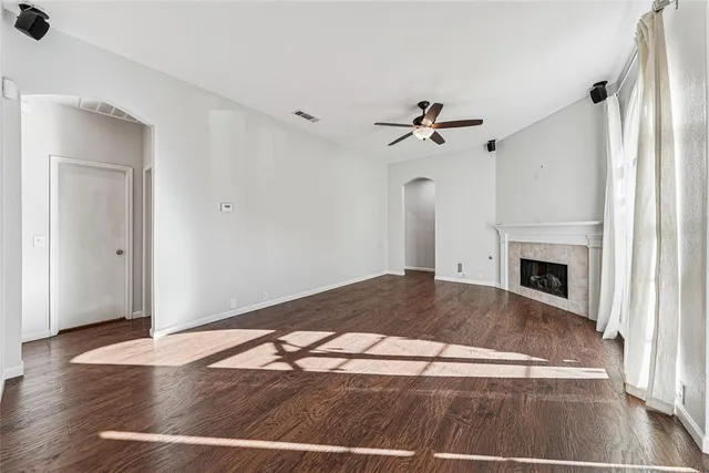 a view of a livingroom with wooden floor and a ceiling fan