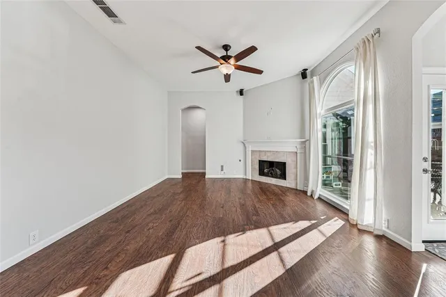 a view of a livingroom with a ceiling fan and window
