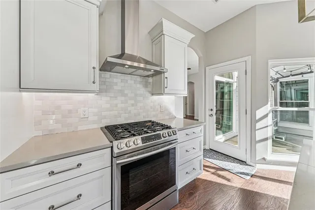a kitchen with granite countertop a stove and a wooden cabinets
