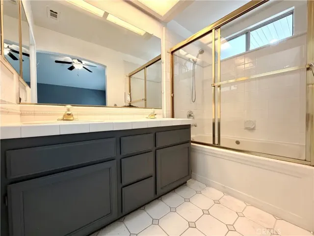 a bathroom with a tub sink and mirror