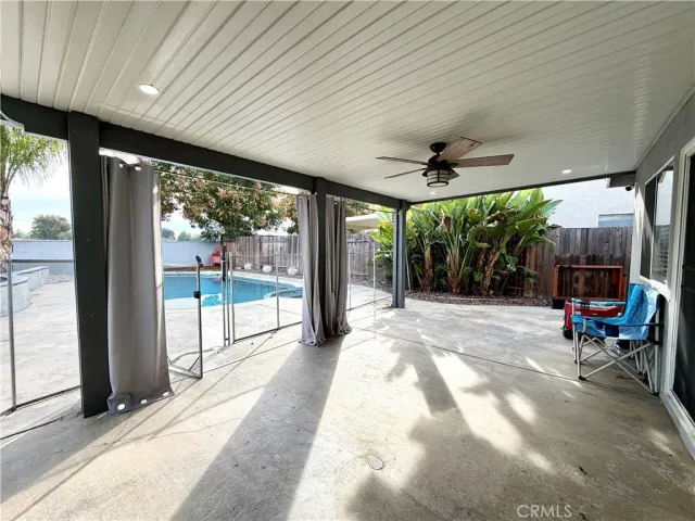 a view of a porch with chairs and backyard