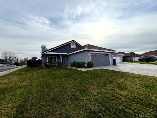 a aerial view of a house next to a big yard and large trees
