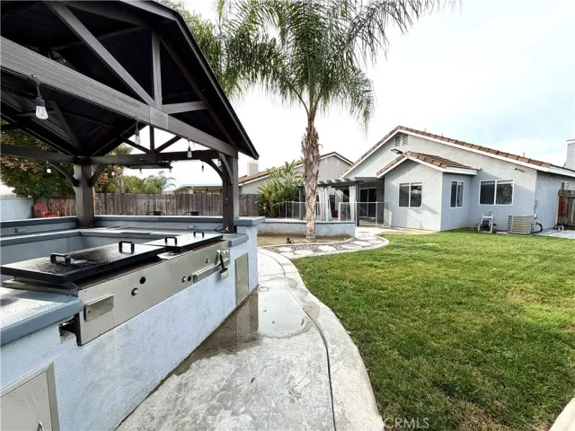 a swimming pool with outdoor seating and yard