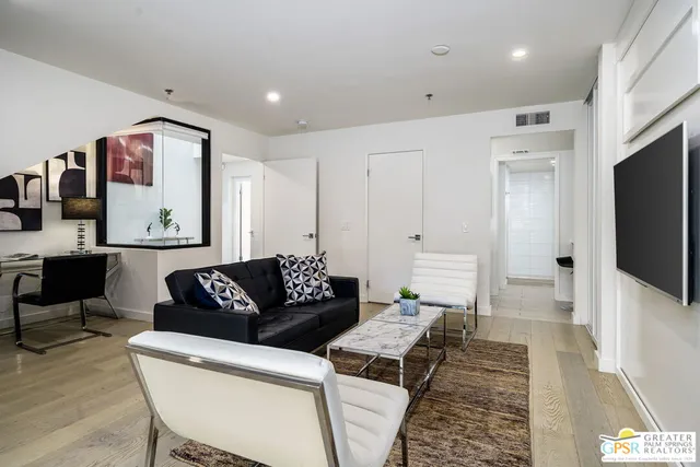 a bathroom with a sink a potted plant and a mirror