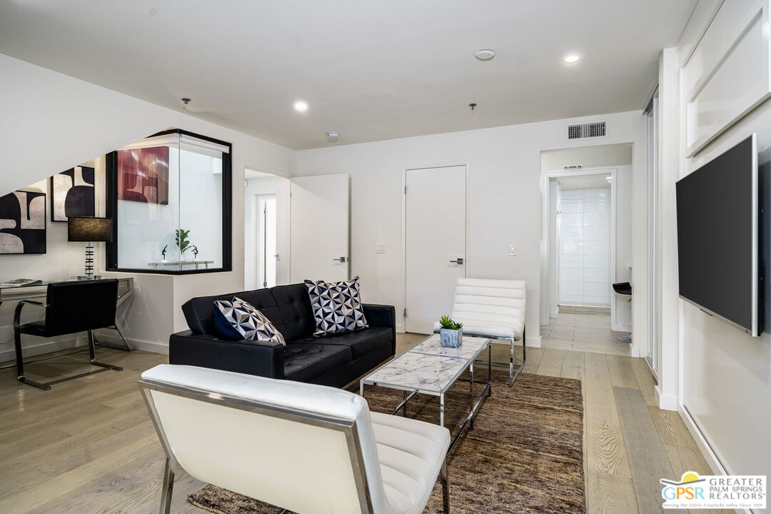 100 East Stevens Road, Unit 513 Palm Springs, CA 92262 - Photo 21 of 26 a living room with furniture and a flat screen tv
