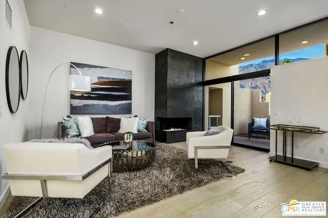a living room with fireplace furniture and a flat screen tv