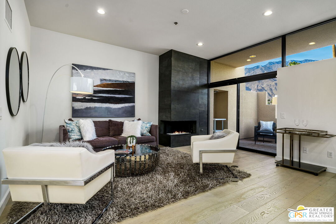 100 East Stevens Road, Unit 513 Palm Springs, CA 92262 - Photo 3 of 26 a living room with fireplace furniture and a flat screen tv