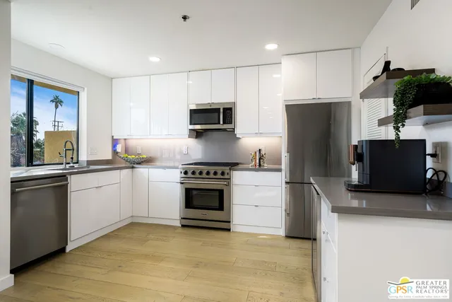 a kitchen with a refrigerator stove and microwave