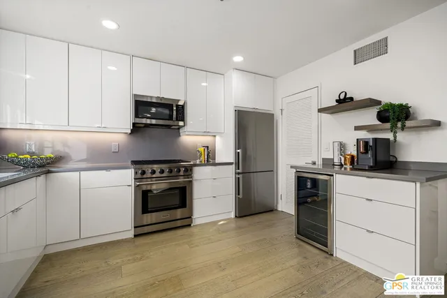 a kitchen with stainless steel appliances a refrigerator stove and microwave