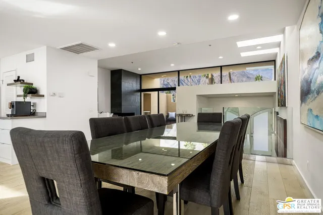 a dining room with furniture a mirror and a chandelier