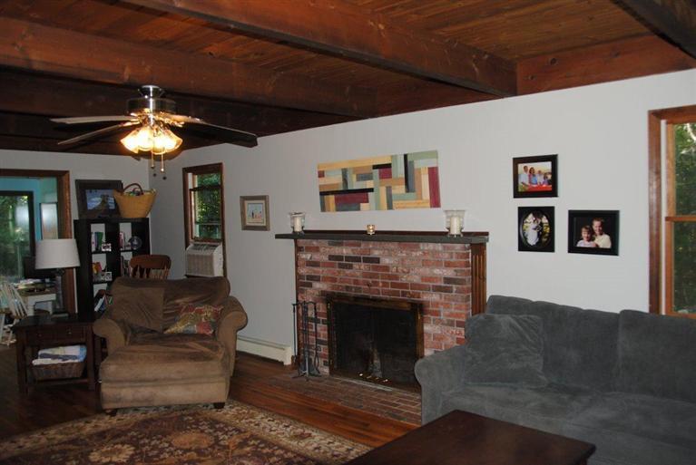16 Union Church Terrace Rochester, MA 02770 - Photo 8 of 17 a living room with furniture a fireplace and a flat screen tv