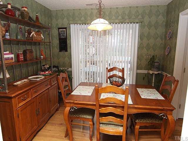 8300 Neuse Rapids Road Raleigh, NC 27616 - Photo 3 of 12 Sliding Glass Door to Deck. Chair Rail & Easy care Laminate Floor.