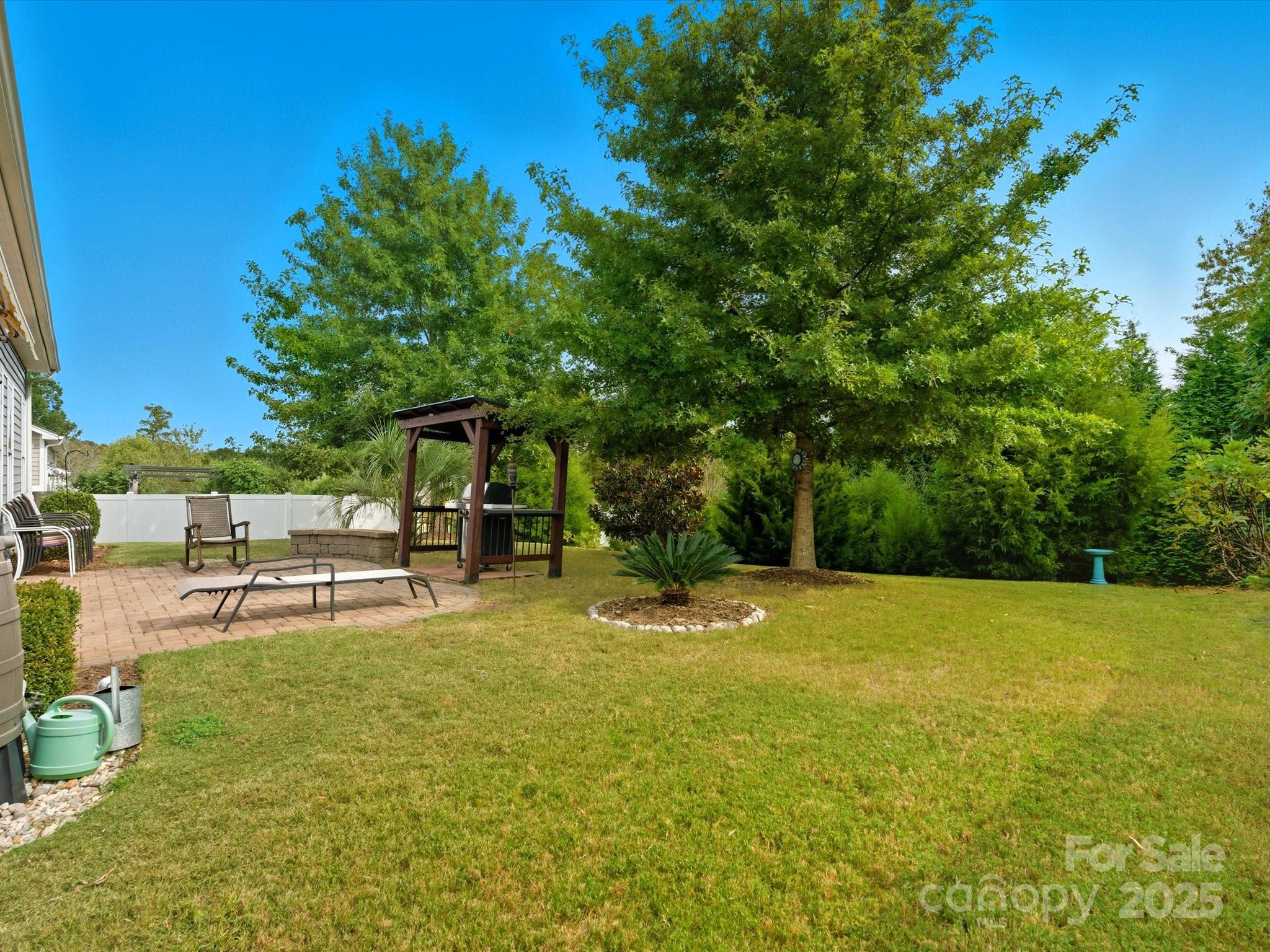1326 Tupelo Road Clover, SC 29710 - Photo 27 of 40 a view of a swimming pool with lawn chairs under an umbrella