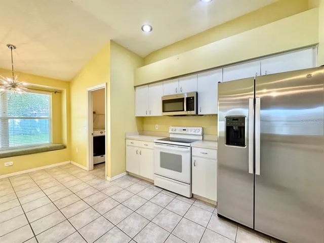 a kitchen with stainless steel appliances a refrigerator sink and microwave