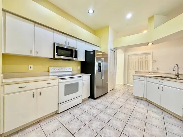 a kitchen with a sink cabinets and stainless steel appliances