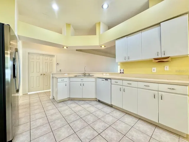 a kitchen with a sink window and cabinets