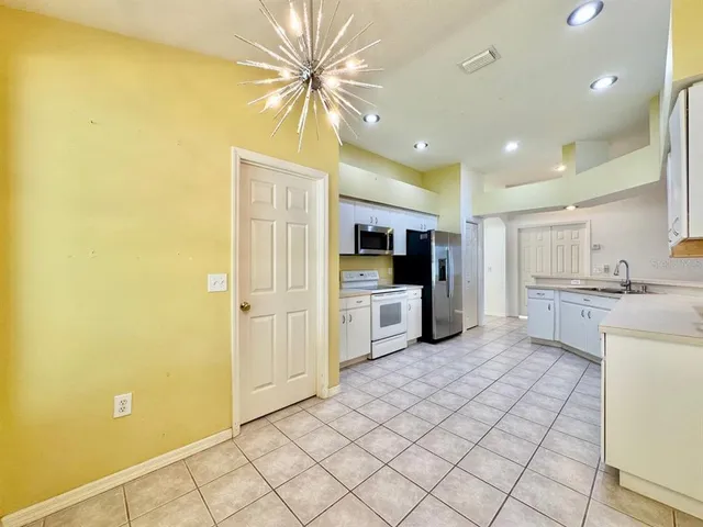a kitchen with a sink and white cabinets