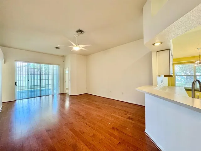 a view of a kitchen with wooden floor and a sink